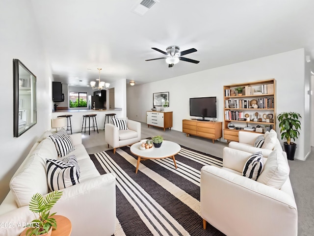 1953 W Stage Driver St, Apache Junction, AZ 85120 - living area featuring a chandelier, light carpet, and a ceiling fan