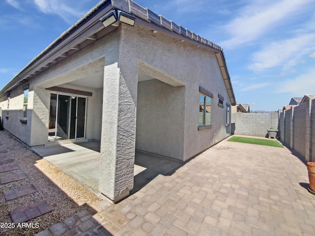 1953 W Stage Driver St, Apache Junction, AZ 85120 - rear view of house with a patio area, a fenced backyard, and stucco siding