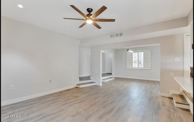 unfurnished living room featuring ceiling fan and light hardwood / wood-style flooring