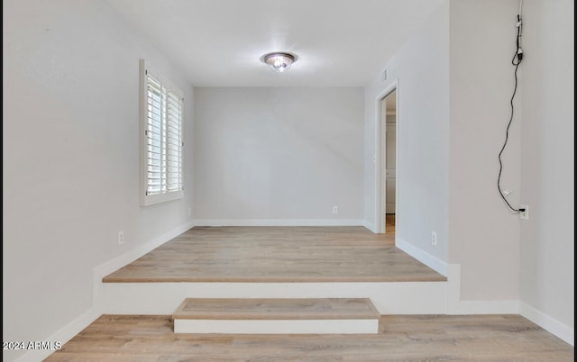 spare room featuring light hardwood / wood-style flooring