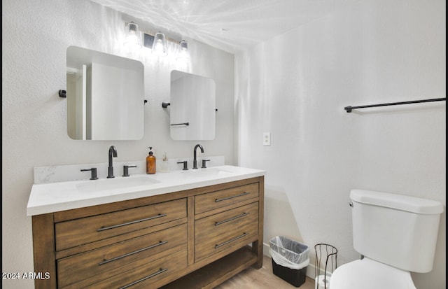 bathroom with hardwood / wood-style flooring, vanity, and toilet