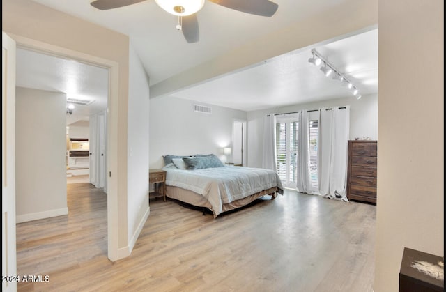 bedroom featuring ceiling fan, light wood-type flooring, and rail lighting