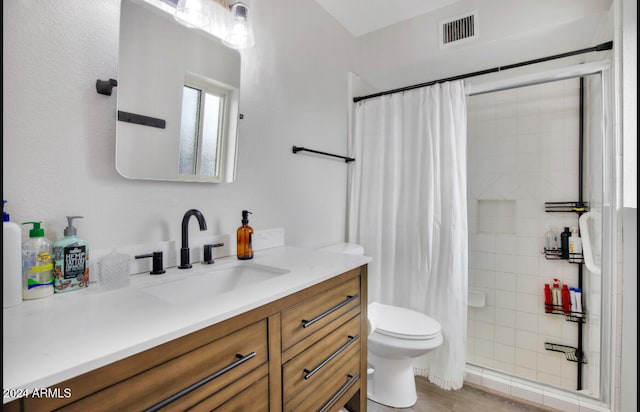 bathroom with hardwood / wood-style flooring, vanity, a shower with shower curtain, and toilet