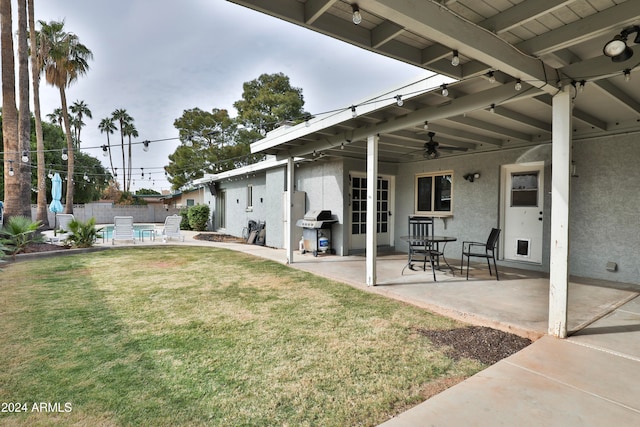 view of yard with a patio area and ceiling fan