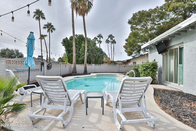 view of swimming pool featuring a patio area