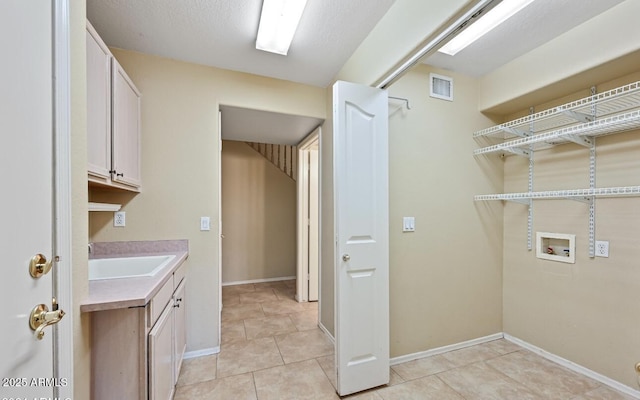 6923 W Laredo St, Chandler, AZ 85226 - laundry room featuring hookup for a washing machine, cabinet space, and light tile patterned flooring