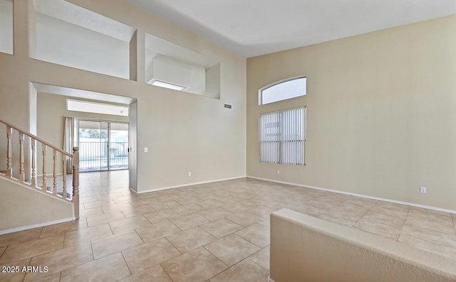 6923 W Laredo St, Chandler, AZ 85226 - unfurnished room with a high ceiling, stairway, and tile patterned flooring