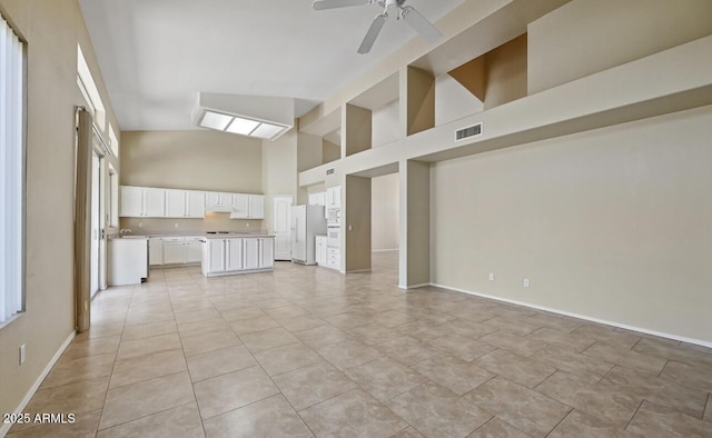 6923 W Laredo St, Chandler, AZ 85226 - unfurnished living room with high vaulted ceiling, a ceiling fan, and light tile patterned floors