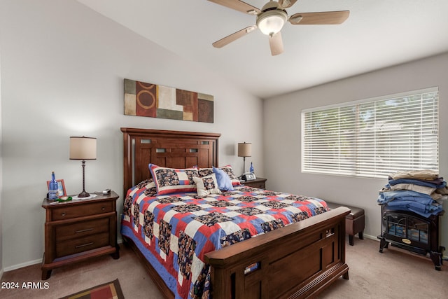 carpeted bedroom featuring ceiling fan and vaulted ceiling