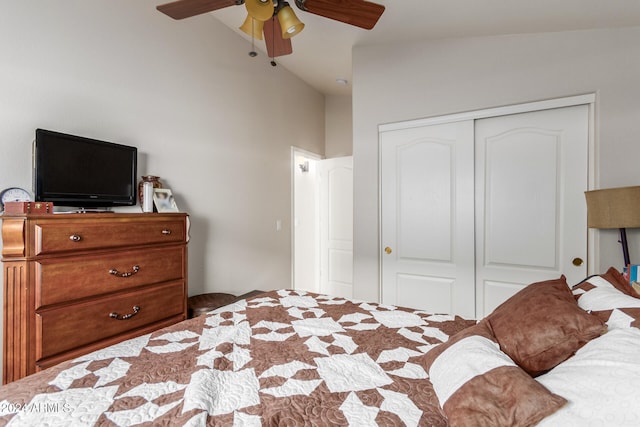 bedroom featuring ceiling fan, a closet, and vaulted ceiling