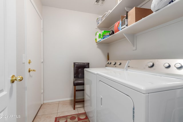 washroom featuring light tile patterned flooring and washing machine and clothes dryer