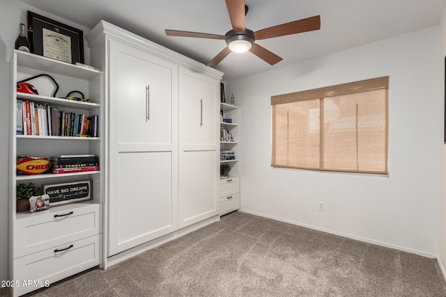 unfurnished bedroom with carpet flooring, a ceiling fan, and baseboards