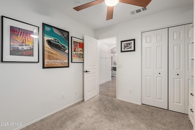 unfurnished bedroom with carpet, visible vents, a closet, and baseboards