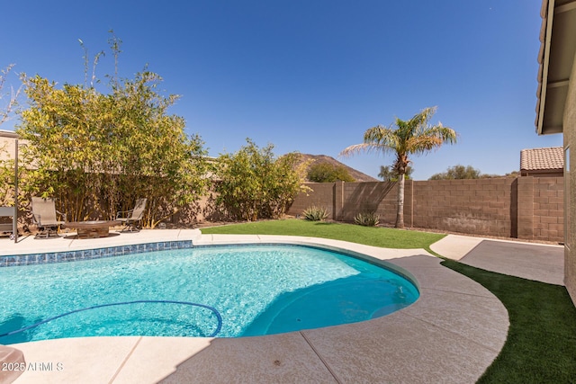 view of swimming pool with a fenced in pool, an outdoor fire pit, a fenced backyard, and a patio area