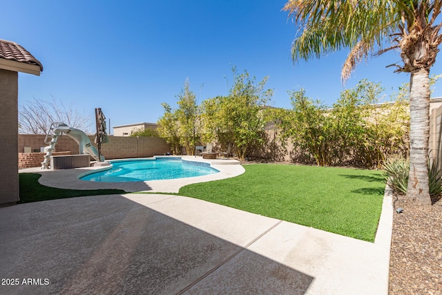 view of swimming pool featuring a yard, a fenced in pool, a fenced backyard, and a patio area