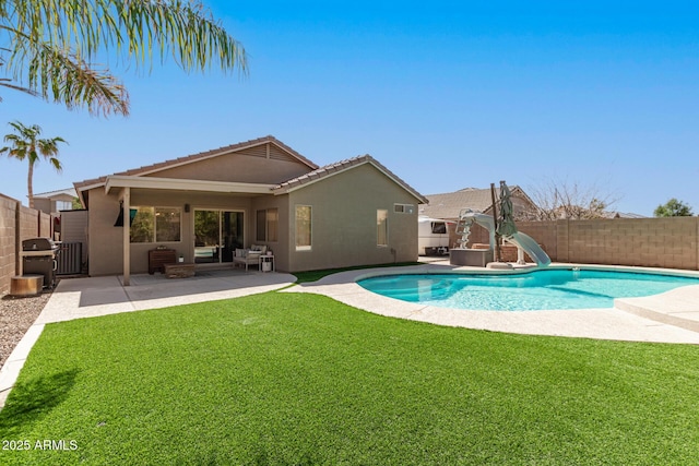 view of swimming pool with a lawn, a fenced backyard, grilling area, a fenced in pool, and a patio area