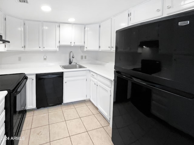 kitchen featuring black appliances, light tile patterned floors, white cabinetry, and sink