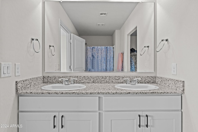 bathroom featuring vanity and a shower with shower curtain