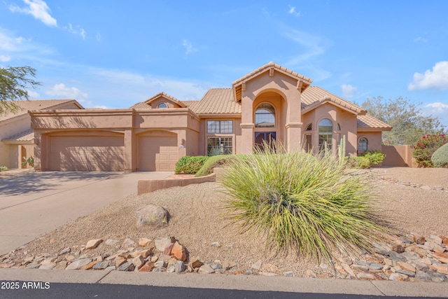 12605 E Kalil Dr, Scottsdale, AZ 85259 - view of front facade featuring a garage, concrete driveway, stucco siding, and a tiled roof
