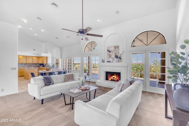 12605 E Kalil Dr, Scottsdale, AZ 85259 - living room with high vaulted ceiling, light carpet, a lit fireplace, recessed lighting, and ceiling fan
