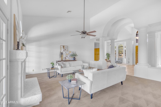 12605 E Kalil Dr, Scottsdale, AZ 85259 - living area with decorative columns, carpet flooring, ceiling fan, and arched walkways