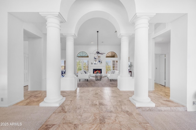 12605 E Kalil Dr, Scottsdale, AZ 85259 - entrance foyer featuring a lit fireplace, a ceiling fan, a towering ceiling, and marble finish flooring
