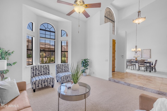 12605 E Kalil Dr, Scottsdale, AZ 85259 - carpeted living area with a high ceiling, a ceiling fan, and a chandelier