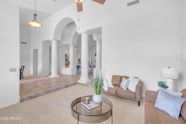 12605 E Kalil Dr, Scottsdale, AZ 85259 - living room featuring carpet, a high ceiling, decorative columns, a ceiling fan, and arched walkways
