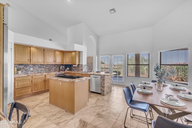 12605 E Kalil Dr, Scottsdale, AZ 85259 - kitchen with dishwasher, high vaulted ceiling, a center island, backsplash, and black electric cooktop