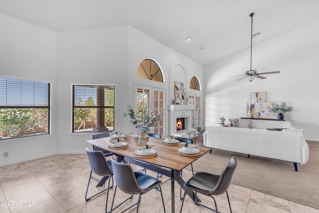 12605 E Kalil Dr, Scottsdale, AZ 85259 - dining room featuring high vaulted ceiling, a warm lit fireplace, light tile patterned flooring, and ceiling fan