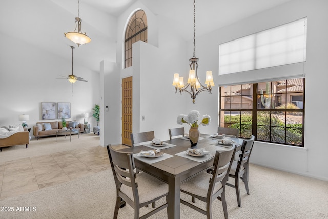 12605 E Kalil Dr, Scottsdale, AZ 85259 - dining area with light colored carpet, a towering ceiling, a chandelier, and ceiling fan