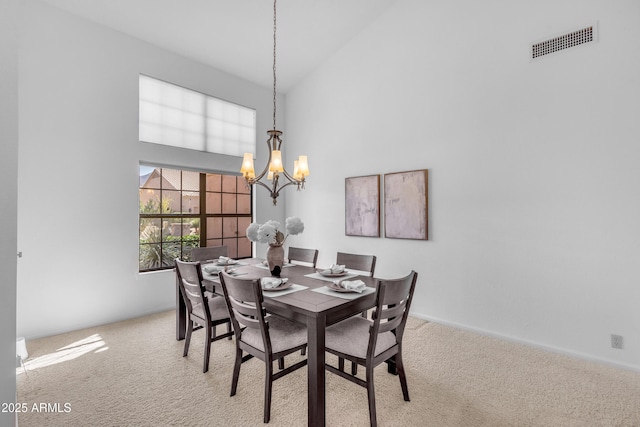 12605 E Kalil Dr, Scottsdale, AZ 85259 - dining space featuring carpet, high vaulted ceiling, and a chandelier