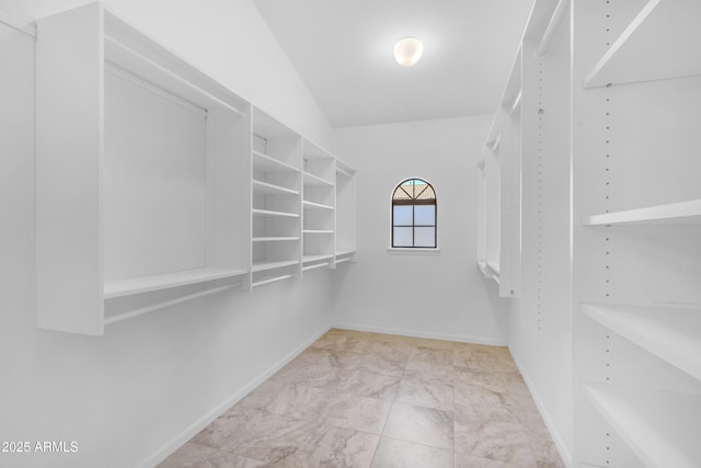 12605 E Kalil Dr, Scottsdale, AZ 85259 - walk in closet featuring marble look tile flooring