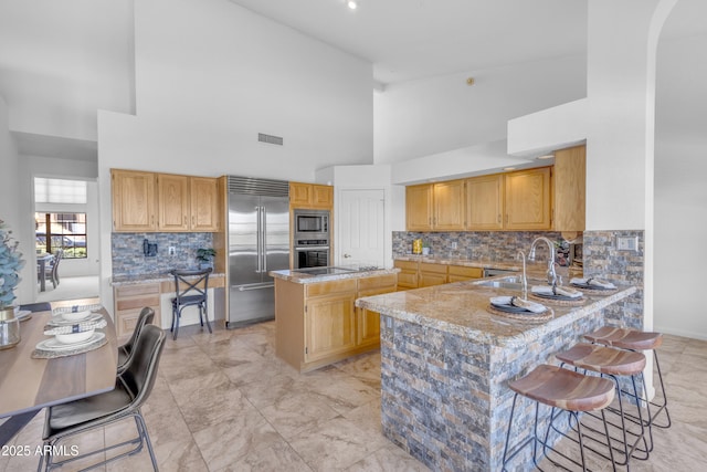 12605 E Kalil Dr, Scottsdale, AZ 85259 - kitchen featuring built in appliances, high vaulted ceiling, a center island, backsplash, and a peninsula