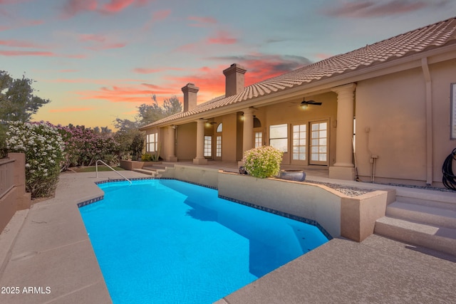 12605 E Kalil Dr, Scottsdale, AZ 85259 - pool at dusk with ceiling fan, an outdoor pool, and a patio