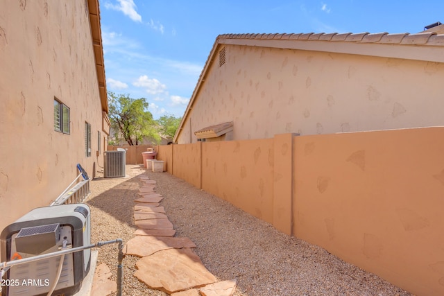 12605 E Kalil Dr, Scottsdale, AZ 85259 - view of side of home featuring a central AC unit and stucco siding
