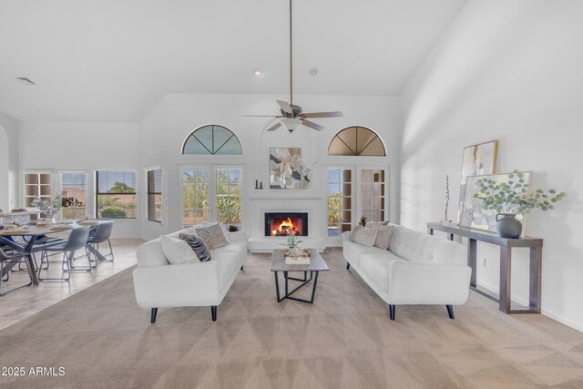 12605 E Kalil Dr, Scottsdale, AZ 85259 - living room with a lit fireplace, a high ceiling, and ceiling fan