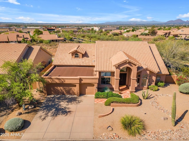 12605 E Kalil Dr, Scottsdale, AZ 85259 - view of front of property featuring concrete driveway, stucco siding, a tile roof, an attached garage, and a mountain view