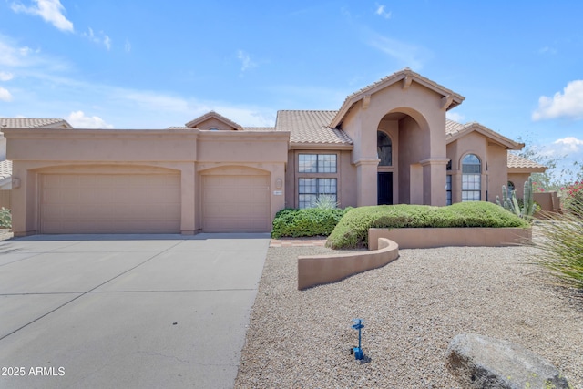 12605 E Kalil Dr, Scottsdale, AZ 85259 - view of front of property with a garage, driveway, a tiled roof, and stucco siding