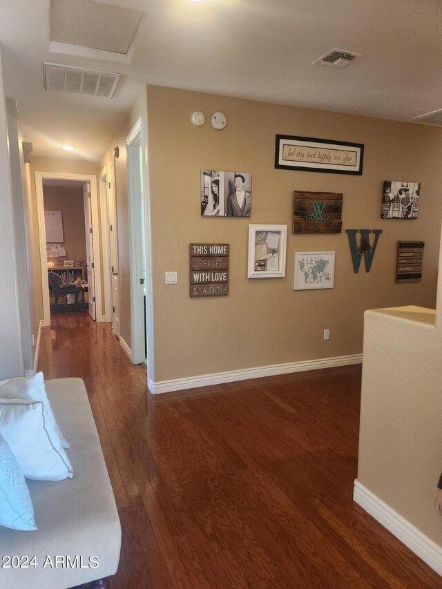 hallway with dark hardwood / wood-style flooring