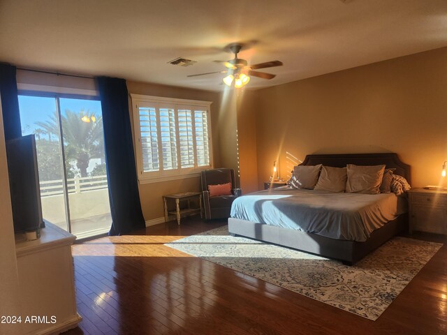 bedroom with dark hardwood / wood-style flooring, access to exterior, and ceiling fan