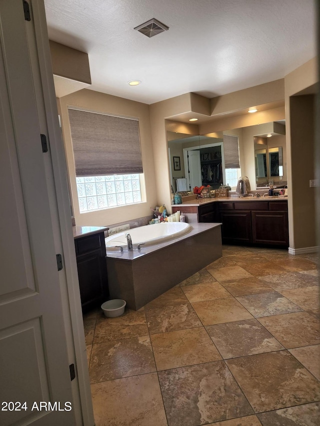 bathroom with vanity and a bathtub