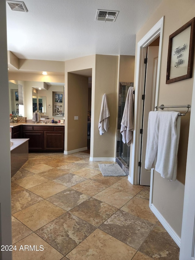 bathroom featuring vanity and a shower with door