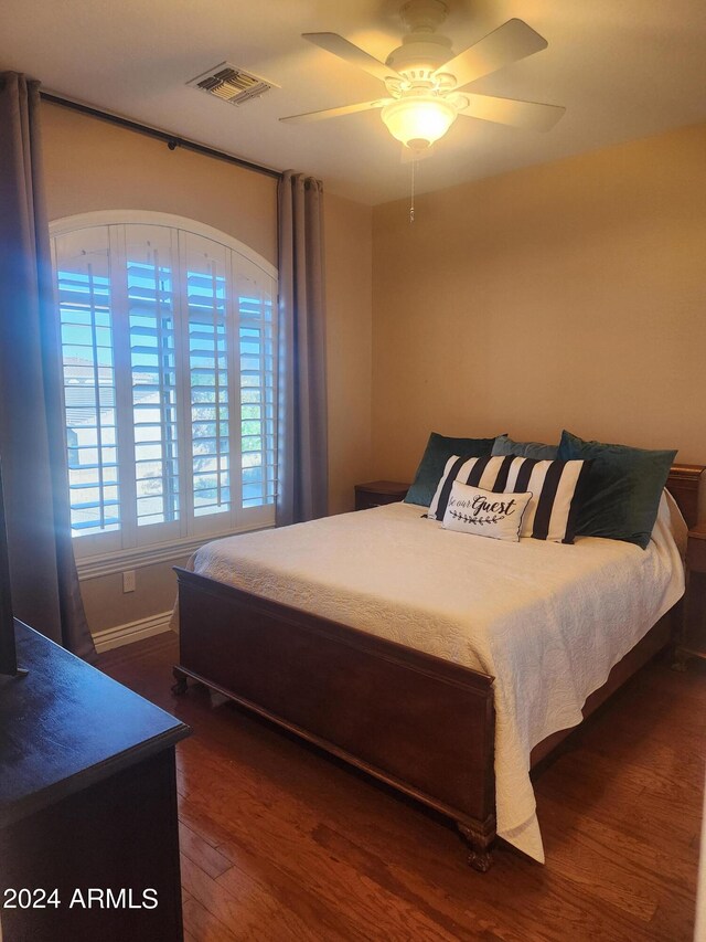 bedroom featuring dark hardwood / wood-style floors and ceiling fan