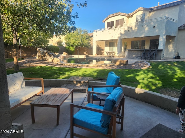 view of patio featuring a balcony and a swimming pool