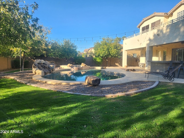 view of yard featuring a patio, a fenced in pool, and a balcony