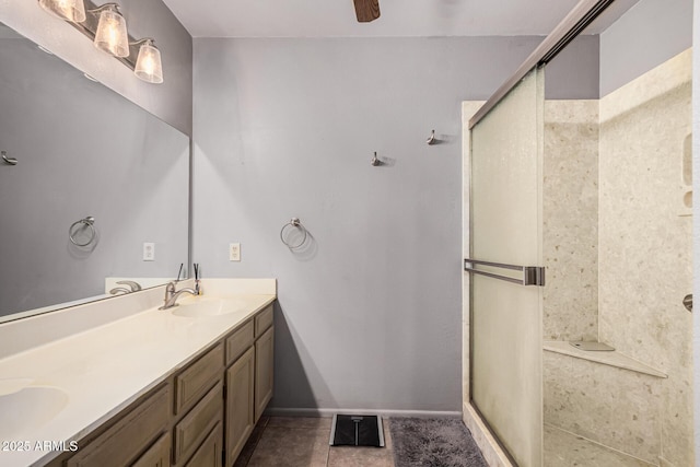 bathroom with a shower with door, vanity, tile patterned floors, and ceiling fan