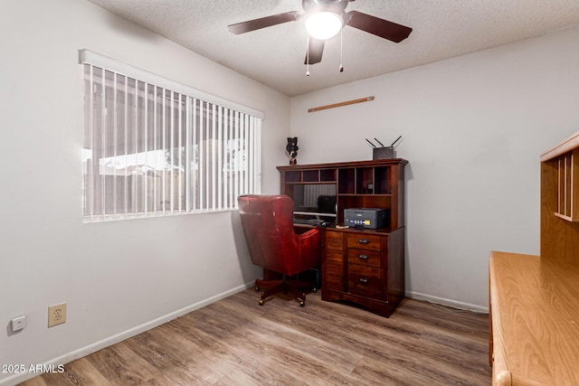 office area featuring hardwood / wood-style flooring, ceiling fan, and a textured ceiling