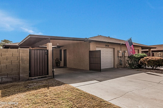 view of front of property with a carport and a garage