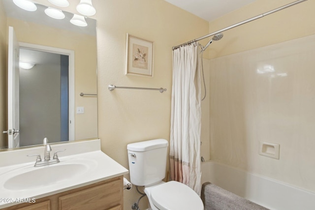 full bathroom featuring shower / bath combo, vanity, and toilet